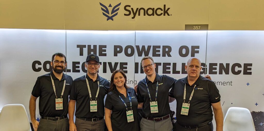 Synack employees in front of the Synack booth at Gartner in National Harbor, MD.