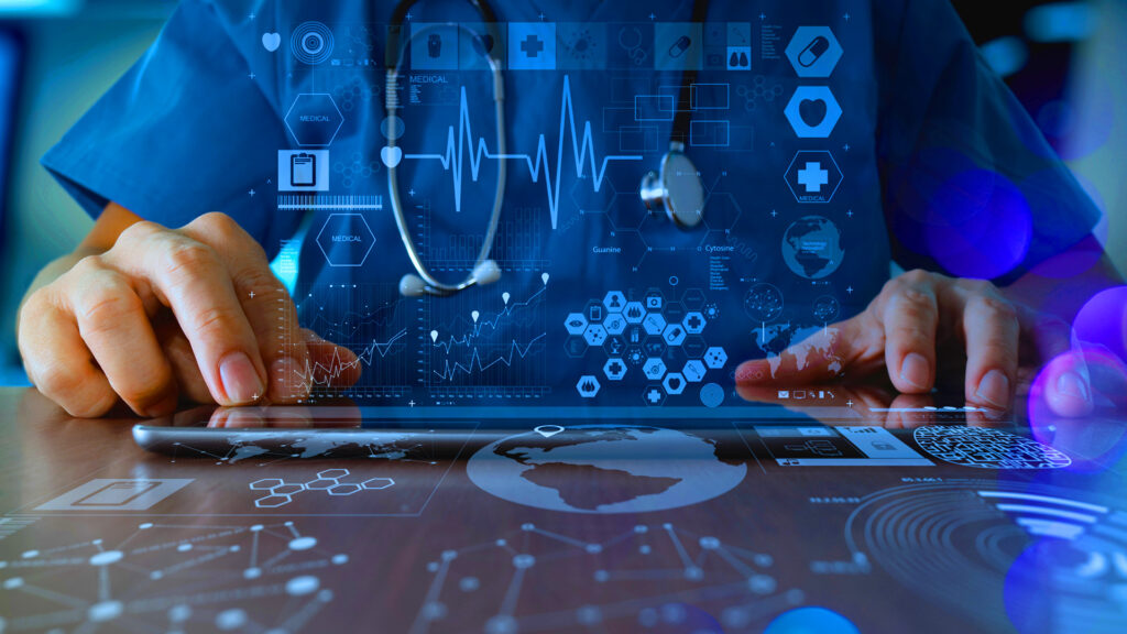 A healthcare professional sitting at a keyboard with an overlay of IT icons to indicate the need for penetration testing for healthcare.