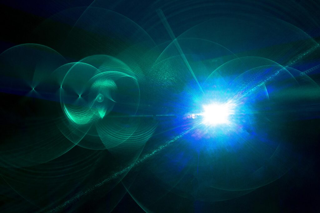 Abstract blue and teal laser light effects on a dark background