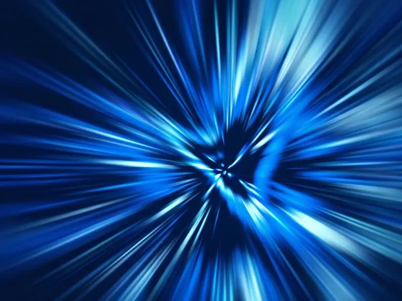 Abstract blue light burst radiating from a central point, representing speed and motion.
